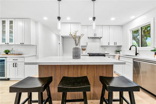 6816 E Driscoll St, Long Beach, CA 90815 - kitchen with dishwasher, wine cooler, white cabinets, tasteful backsplash, and recessed lighting