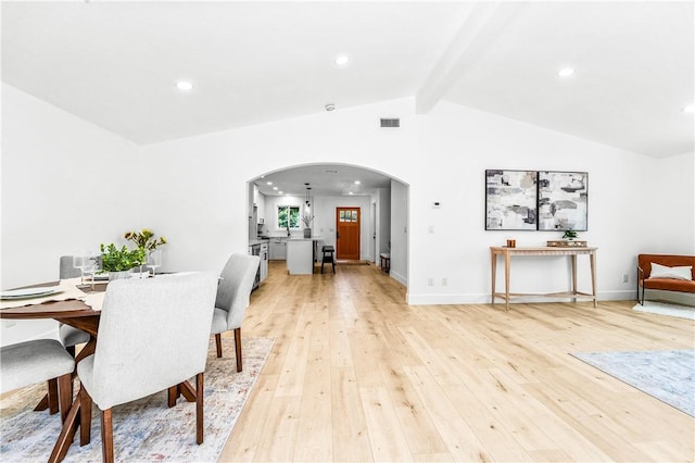 6816 E Driscoll St, Long Beach, CA 90815 - dining room featuring arched walkways, light wood-style floors, and recessed lighting
