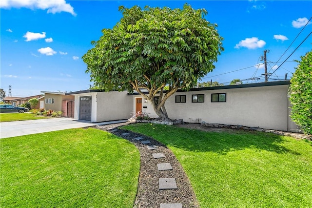6816 E Driscoll St, Long Beach, CA 90815 - view of front of home featuring stucco siding, driveway, an attached garage, and a front yard