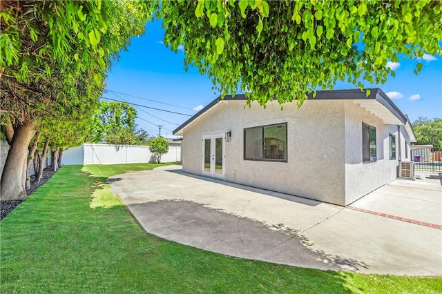 6816 E Driscoll St, Long Beach, CA 90815 - rear view of house with stucco siding, a fenced backyard, french doors, and a patio
