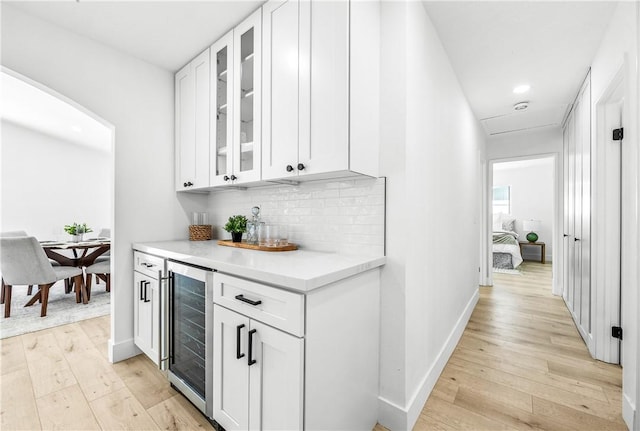 6816 E Driscoll St, Long Beach, CA 90815 - indoor dry bar with beverage cooler, light wood-style floors, tasteful backsplash, and recessed lighting
