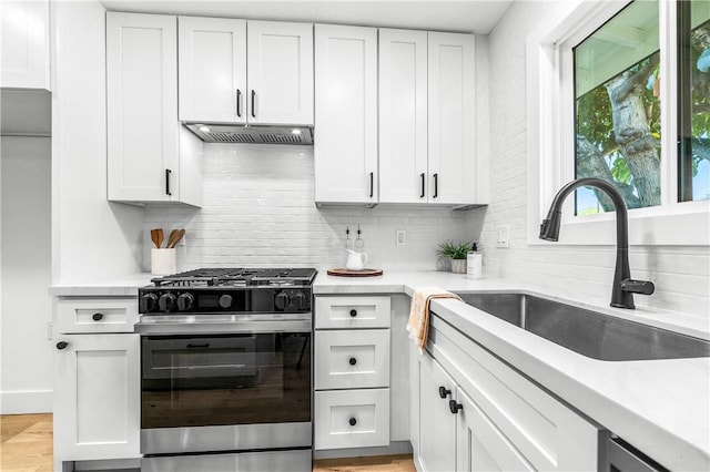 6816 E Driscoll St, Long Beach, CA 90815 - kitchen with range with gas stovetop, extractor fan, tasteful backsplash, and light countertops