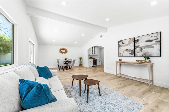 6816 E Driscoll St, Long Beach, CA 90815 - living area with arched walkways, light wood finished floors, recessed lighting, and beverage cooler