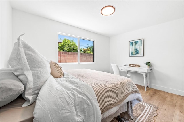 6816 E Driscoll St, Long Beach, CA 90815 - bedroom with light wood-style floors and baseboards