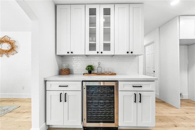 6816 E Driscoll St, Long Beach, CA 90815 - indoor dry bar with wine cooler, light wood-style flooring, and backsplash