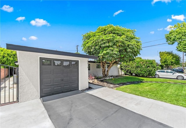 6816 E Driscoll St, Long Beach, CA 90815 - view of front facade with stucco siding, driveway, a front lawn, and an attached garage