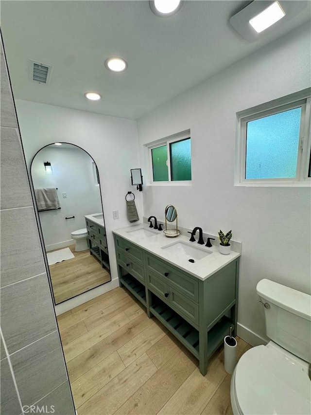 6816 E Driscoll St, Long Beach, CA 90815 - bathroom with wood finished floors, double vanity, and recessed lighting