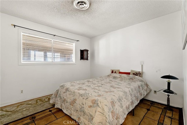 57795 El Dorado Dr, Yucca Valley, CA 92284 - bedroom with tile patterned floors and a textured ceiling