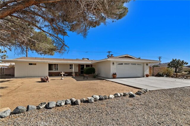 57795 El Dorado Dr, Yucca Valley, CA 92284 - ranch-style house with concrete driveway and an attached garage
