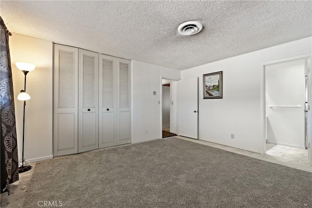 57795 El Dorado Dr, Yucca Valley, CA 92284 - unfurnished bedroom featuring a textured ceiling, a closet, and carpet floors