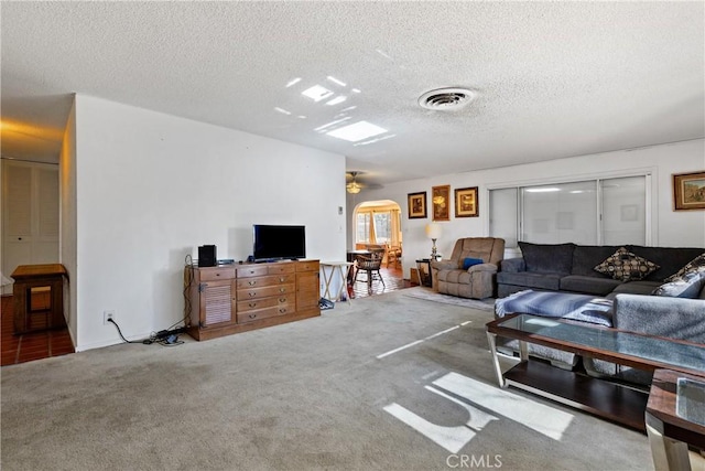 57795 El Dorado Dr, Yucca Valley, CA 92284 - living room with ceiling fan, carpet, and a textured ceiling
