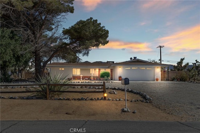 57795 El Dorado Dr, Yucca Valley, CA 92284 - view of front of house featuring a fenced front yard, driveway, and an attached garage