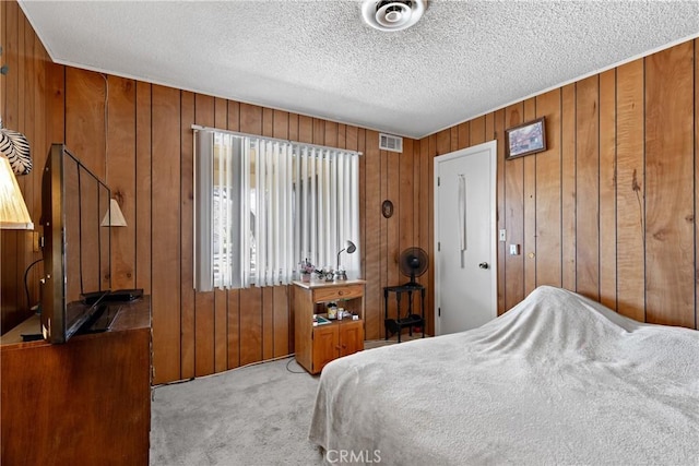 57795 El Dorado Dr, Yucca Valley, CA 92284 - bedroom with wooden walls, carpet, and a textured ceiling