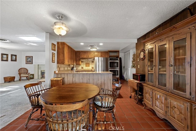 57795 El Dorado Dr, Yucca Valley, CA 92284 - dining space featuring dark tile patterned flooring, a textured ceiling, and recessed lighting