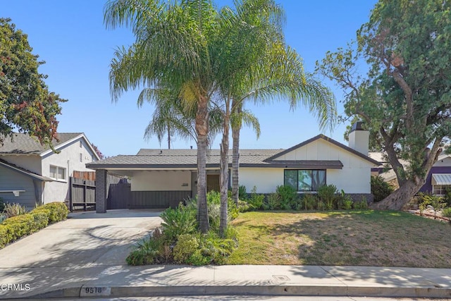 9518 Forbes Ave, Northridge, CA 91343 - view of front of house featuring driveway, an attached carport, a chimney, and stucco siding
