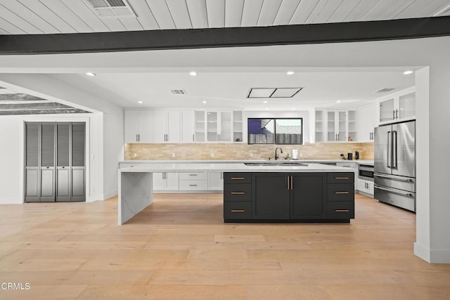9518 Forbes Ave, Northridge, CA 91343 - kitchen featuring appliances with stainless steel finishes, a center island, white cabinets, light countertops, and beam ceiling