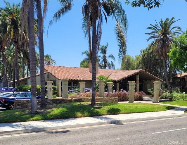 1345 Cabrillo Park Dr Unit A06, Santa Ana, CA 92701 - view of front facade featuring a tile roof, stucco siding, and a front lawn