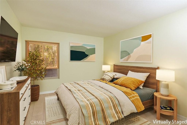 1345 Cabrillo Park Dr Unit A06, Santa Ana, CA 92701 - bedroom featuring baseboards and light wood-style flooring