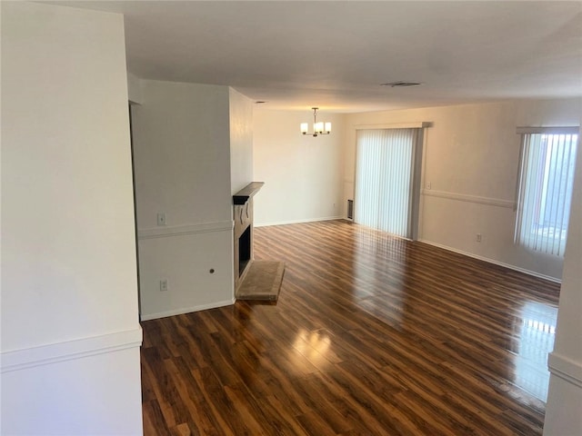 1060 Golden Springs Dr Unit B, Diamond Bar, CA 91765 - empty room featuring a chandelier, dark wood-type flooring, and a fireplace with raised hearth