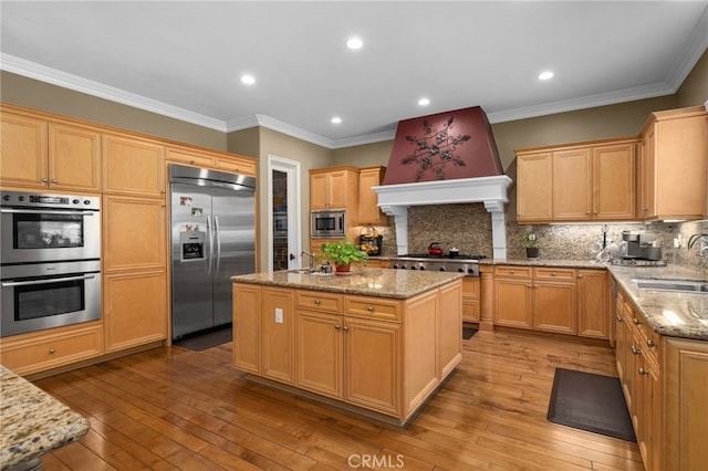 13812 Breeders Cup Dr, Rancho Cucamonga, CA 91739 - kitchen with built in appliances, a kitchen island, backsplash, hardwood / wood-style floors, and light stone countertops