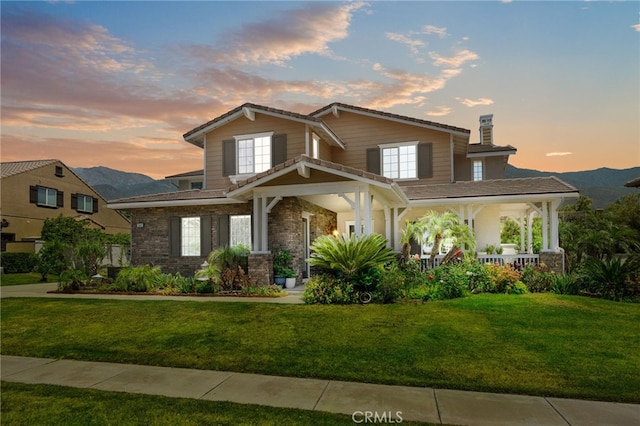 13812 Breeders Cup Dr, Rancho Cucamonga, CA 91739 - view of front of property featuring covered porch, a yard, a chimney, and a mountain view