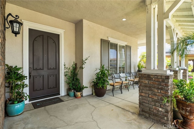 13812 Breeders Cup Dr, Rancho Cucamonga, CA 91739 - doorway to property featuring a porch and stucco siding