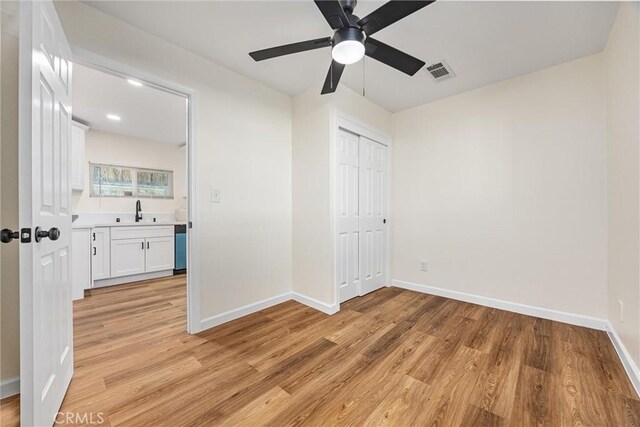 326 Water St, Bakersfield, CA 93305 - unfurnished bedroom with light wood finished floors, a closet, and a ceiling fan