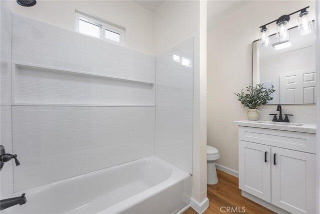 326 Water St, Bakersfield, CA 93305 - bathroom with vanity, wood finished floors, and bathtub / shower combination