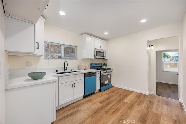 326 Water St, Bakersfield, CA 93305 - kitchen featuring stainless steel appliances, white cabinetry, light wood-type flooring, light countertops, and recessed lighting