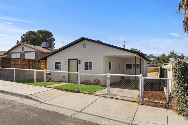 326 Water St, Bakersfield, CA 93305 - view of front facade featuring a fenced front yard, stucco siding, and a gate
