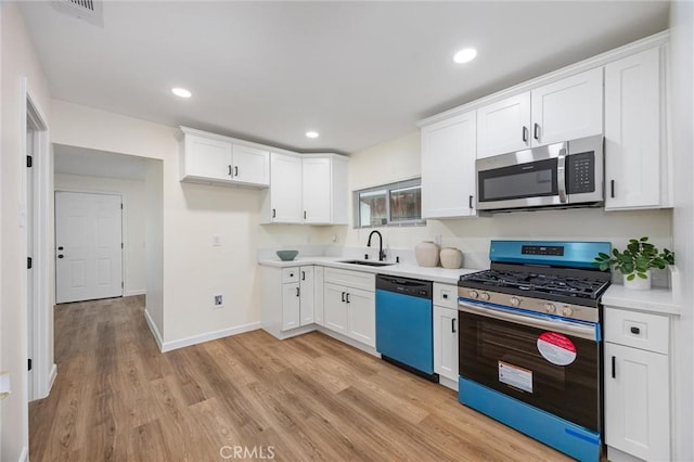 326 Water St, Bakersfield, CA 93305 - kitchen with stainless steel appliances, white cabinets, light wood-type flooring, light countertops, and recessed lighting