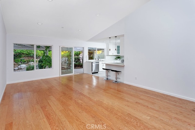 22570 Napa St, West Hills, CA 91304 - unfurnished living room featuring vaulted ceiling, light wood finished floors, and recessed lighting