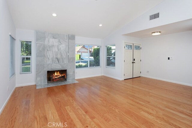 22570 Napa St, West Hills, CA 91304 - unfurnished living room featuring vaulted ceiling, a fireplace, light wood-style flooring, and recessed lighting