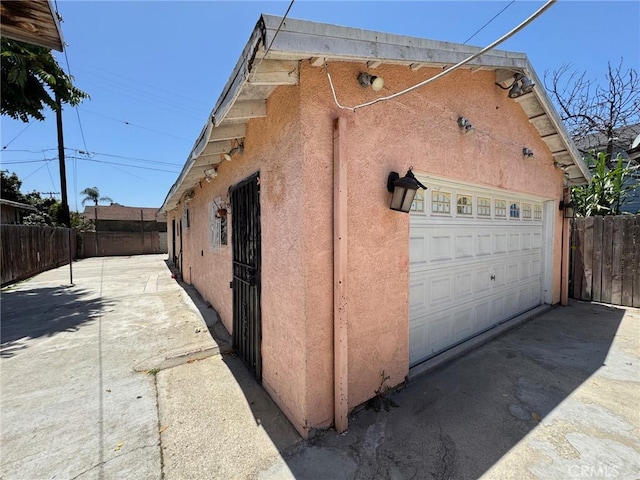 1442 E 76th Pl, Los Angeles, CA 90001 - view of side of home with stucco siding and a garage