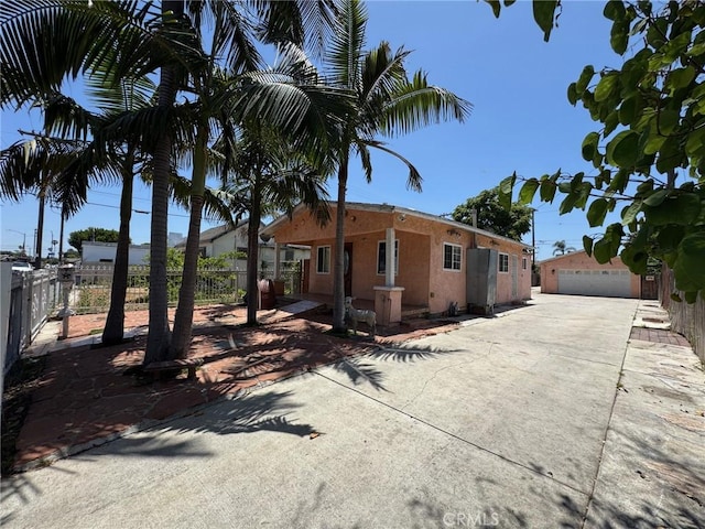 1442 E 76th Pl, Los Angeles, CA 90001 - view of front of home with stucco siding and a garage