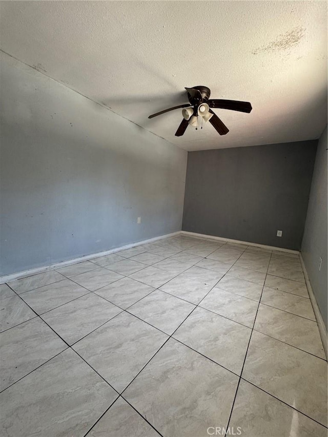 1442 E 76th Pl, Los Angeles, CA 90001 - unfurnished room featuring a textured ceiling, ceiling fan, and light tile patterned flooring