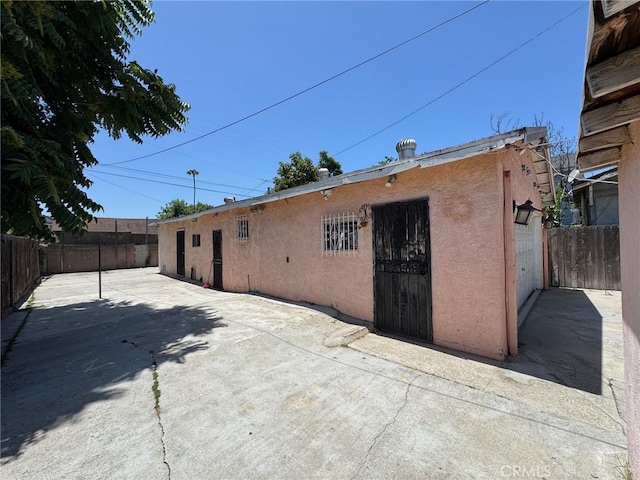 1442 E 76th Pl, Los Angeles, CA 90001 - back of property featuring stucco siding and a patio area