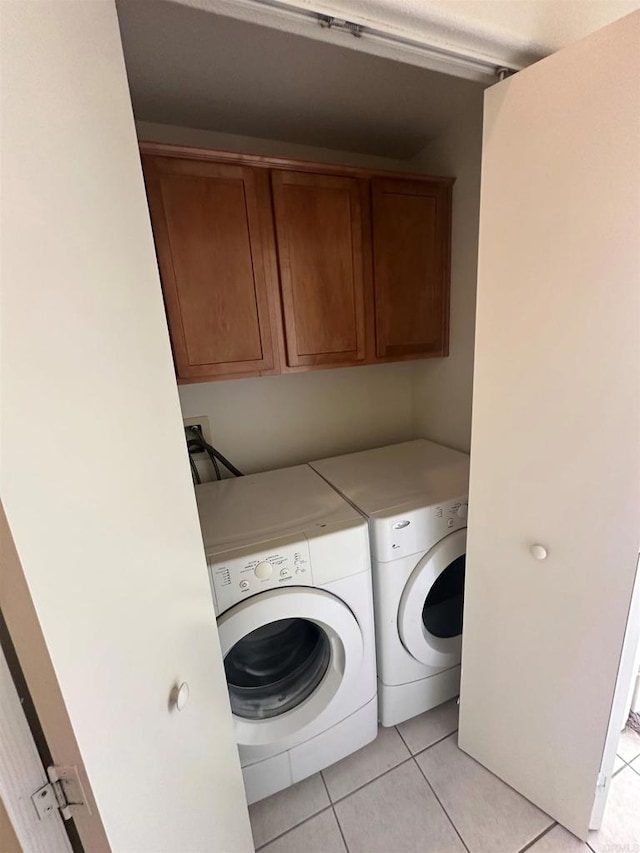 31100 Desert Palm Dr, Thousand Palms, CA 92276 - laundry area with washing machine and clothes dryer, cabinet space, and light tile patterned floors