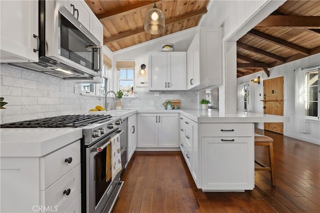 135 Turquoise Ave, Newport Beach, CA 92662 - kitchen featuring stainless steel appliances, wood ceiling, a peninsula, light countertops, and dark wood-type flooring