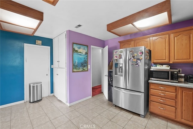 1002 N Iroquois Ave, Anaheim, CA 92801 - kitchen with stainless steel appliances, light countertops, brown cabinets, and light tile patterned floors