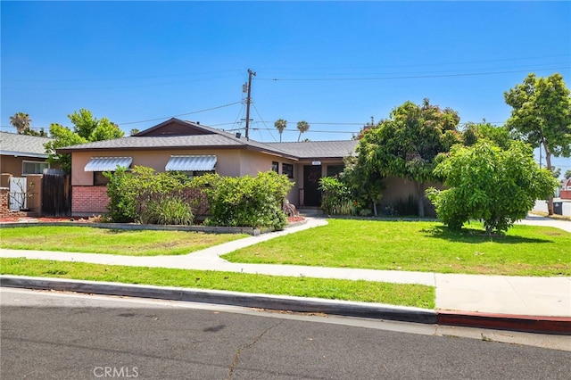 1002 N Iroquois Ave, Anaheim, CA 92801 - ranch-style house featuring a front yard and stucco siding