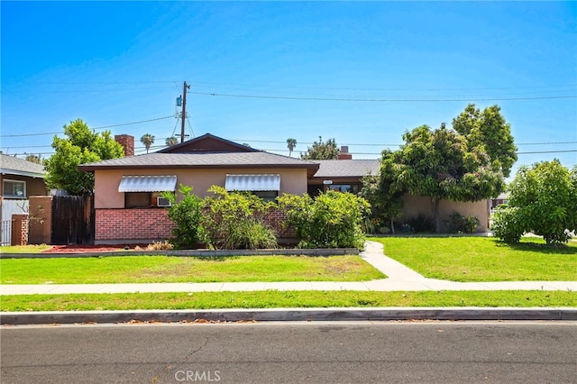 1002 N Iroquois Ave, Anaheim, CA 92801 - view of front of home with brick siding, stucco siding, and a front yard
