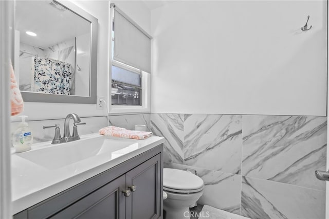 1002 N Iroquois Ave, Anaheim, CA 92801 - full bath with tile walls, vanity, a shower with shower curtain, and wainscoting