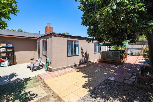 1002 N Iroquois Ave, Anaheim, CA 92801 - rear view of house featuring a patio area, a chimney, and brick siding