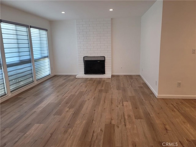 6091 Larchwood Dr, Huntington Beach, CA 92647 - unfurnished living room featuring a brick fireplace, wood finished floors, and recessed lighting