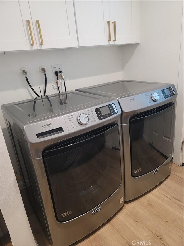6091 Larchwood Dr, Huntington Beach, CA 92647 - laundry room featuring cabinet space, light wood finished floors, and washing machine and clothes dryer