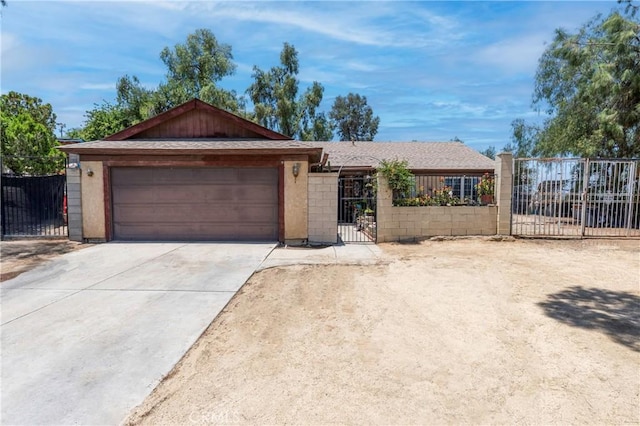 4760 Crest Ave, Riverside, CA 92503 - ranch-style home with an attached garage, concrete driveway, and a gate