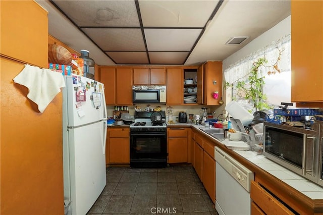 4760 Crest Ave, Riverside, CA 92503 - kitchen featuring white appliances, tile countertops, dark tile patterned flooring, and open shelves