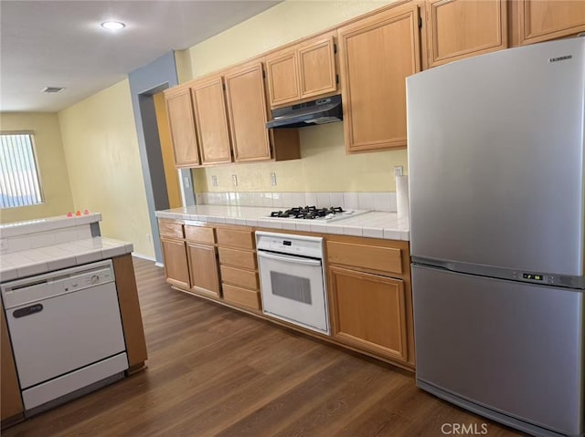 12673 Field Way, Victorville, CA 92395 - kitchen with white appliances, under cabinet range hood, dark wood-type flooring, tile counters, and recessed lighting