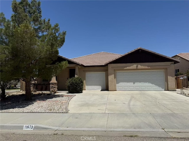 12673 Field Way, Victorville, CA 92395 - ranch-style house with a tiled roof, an attached garage, stucco siding, and concrete driveway